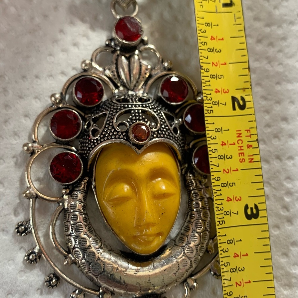 Gorgeous sleeping carved face pendant.